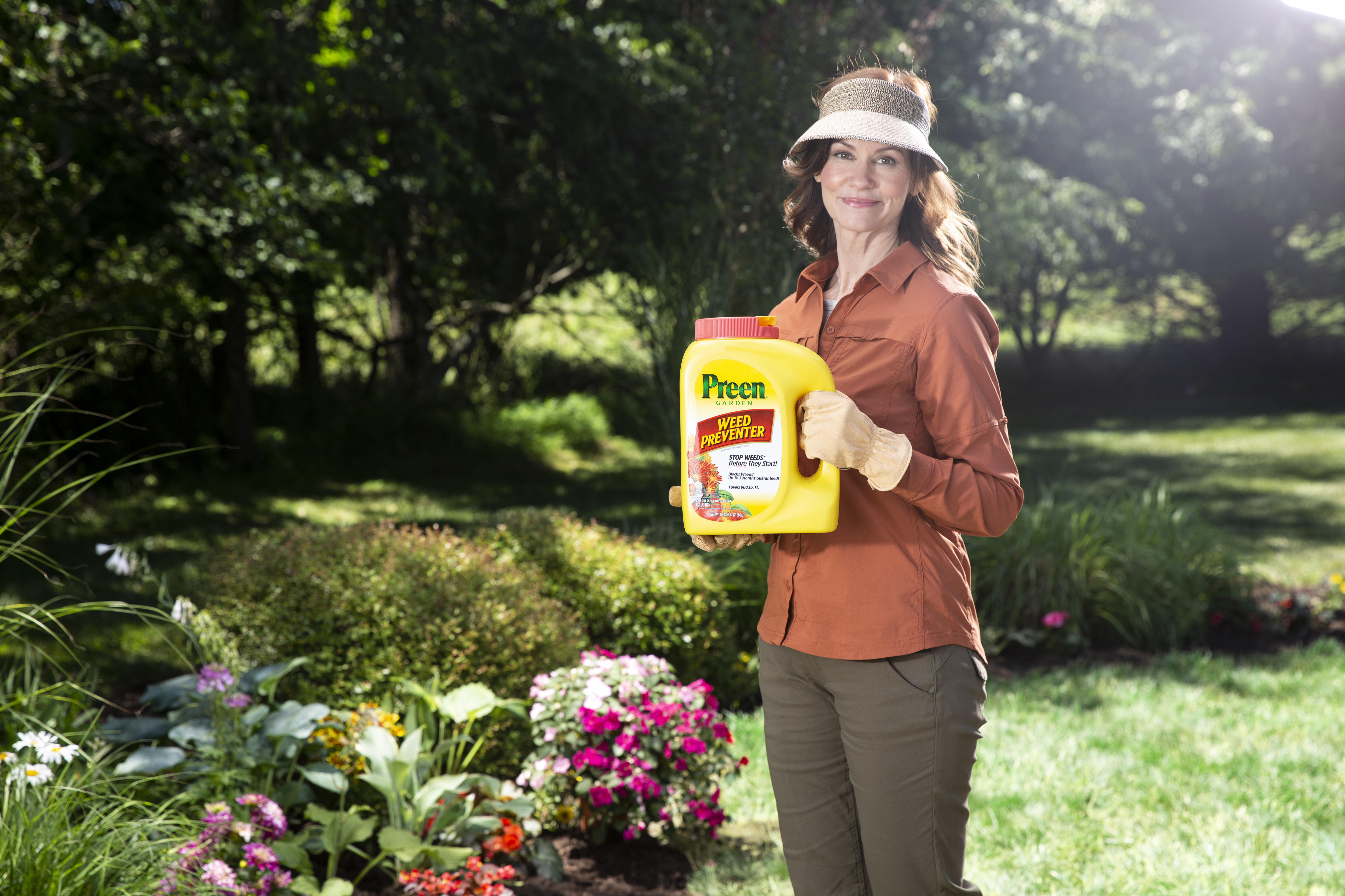 Happy woman holding Preen in the garden