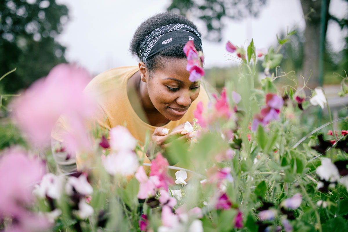 Woman enjoying fragrant garden flowers